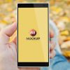 Man-in-Park-Holding-Smartphone-Mockup-Free-Psd