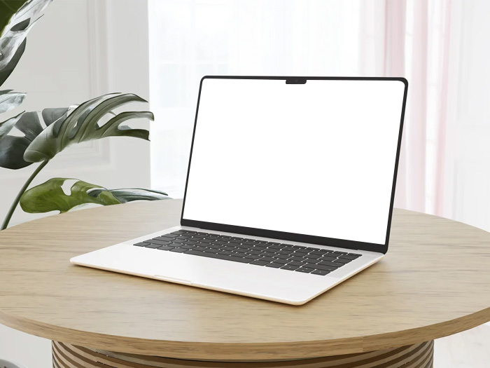 Free-MacBook-on-a-wooden-Table-Mockup-Design