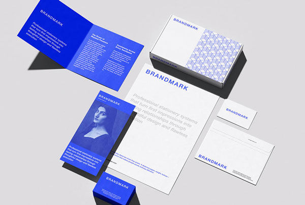 A complete corporate stationery mockup showcasing a customizable branding kit, including a letterhead, business cards, envelopes, and a notebook laid out with realistic shadows.