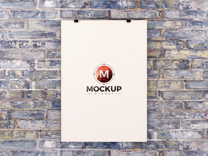 Free Poster Hanging Over Brick Wall Mockup PSD - Mockup Planet