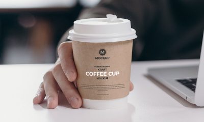 Free-Person-Holding-Kraft-Coffee-Cup-Mockup-Design