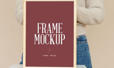Free-Woman-Holding-Wooden-Frame-Mockup-Design