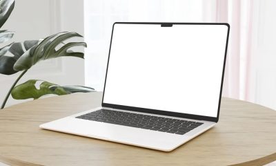 Free-MacBook-on-a-wooden-Table-Mockup-Design