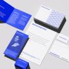 A complete corporate stationery mockup showcasing a customizable branding kit, including a letterhead, business cards, envelopes, and a notebook laid out with realistic shadows.