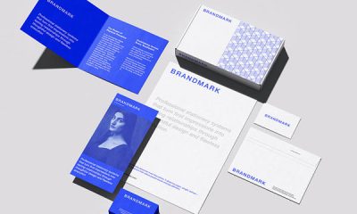 A complete corporate stationery mockup showcasing a customizable branding kit, including a letterhead, business cards, envelopes, and a notebook laid out with realistic shadows.